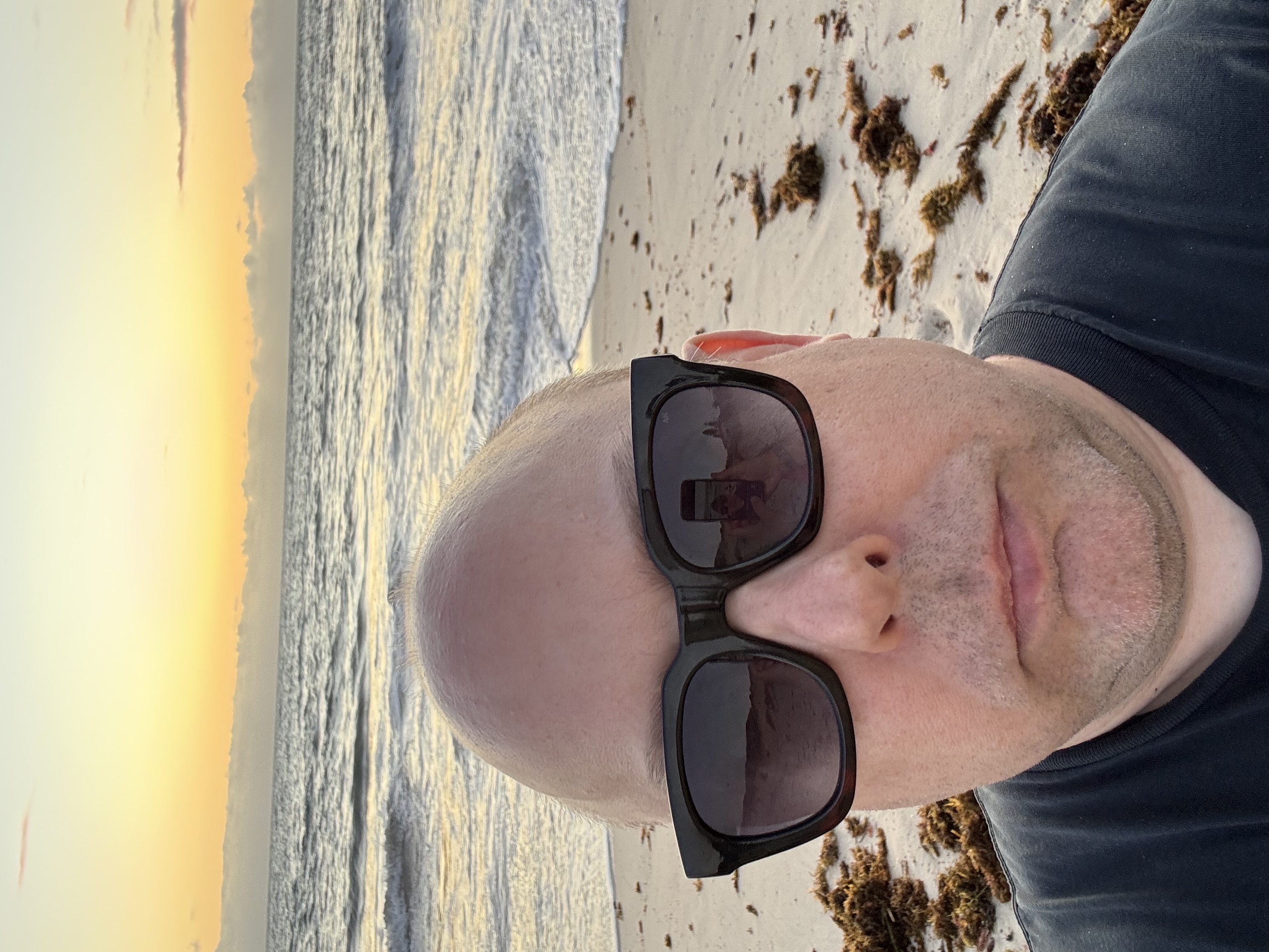 Mikko Kärenlampi on a beach at sunset